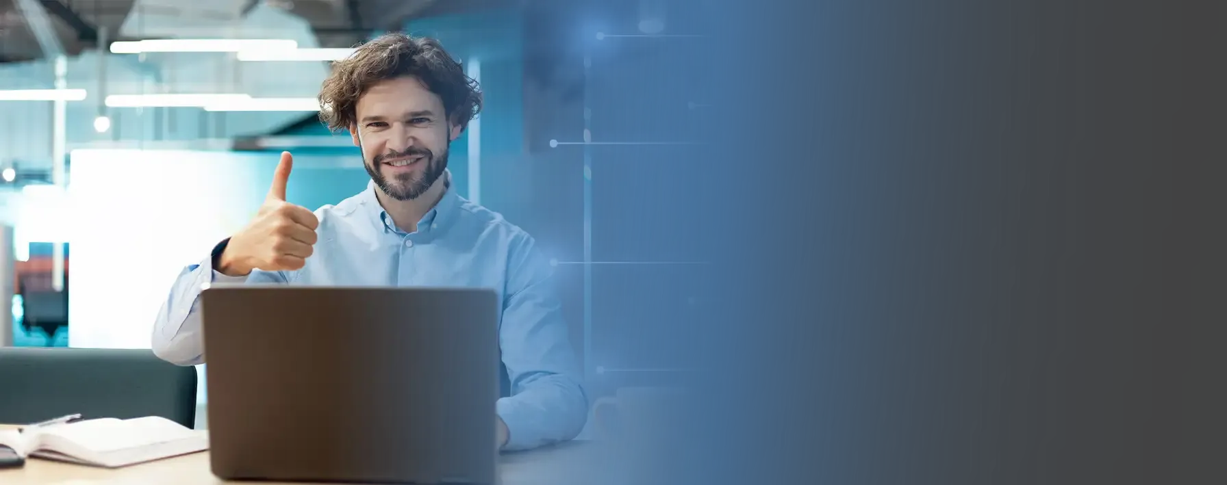 Man giving thumbs up with a laptop